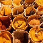 A vibrant display of spices in sacks at a market in Marseille, France.